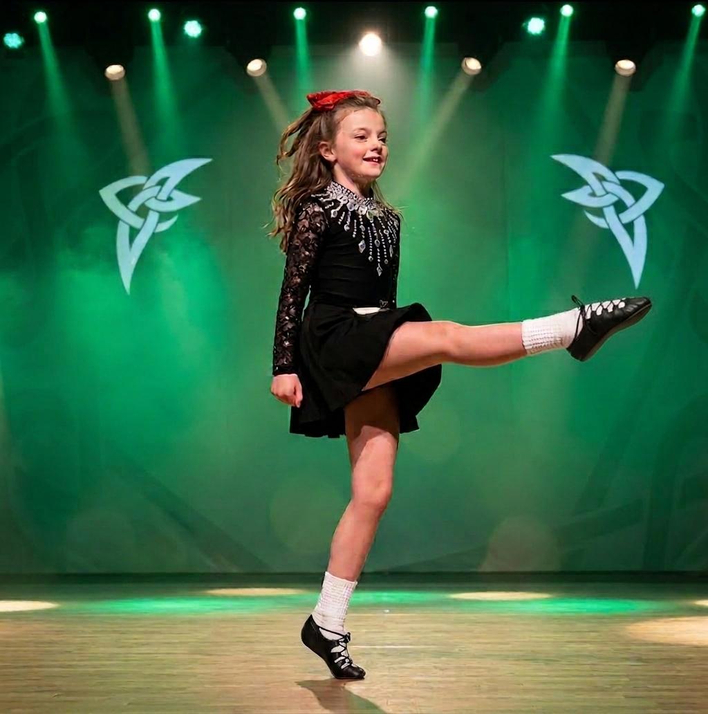 Irish dancer performing on stage at the Leinster Feis